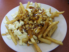 Poutine is a french fry dish of Quebec, Canada, origin. It consists of french fries topped with gravy (usually made of beef), and cheese curds.